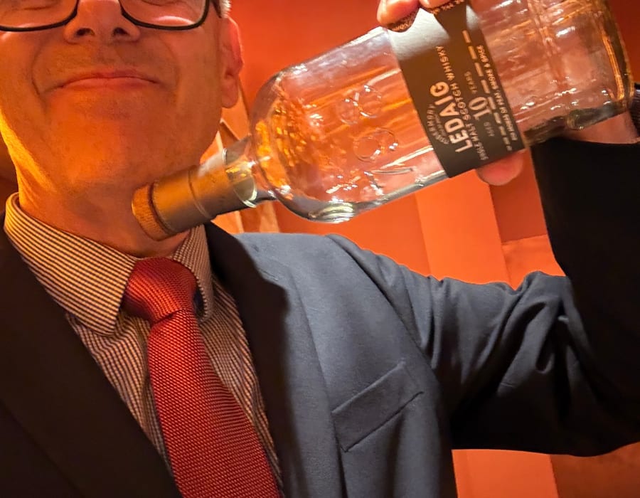 Gregor Cattanach holding a bottle of Ledaig 10 Year Old